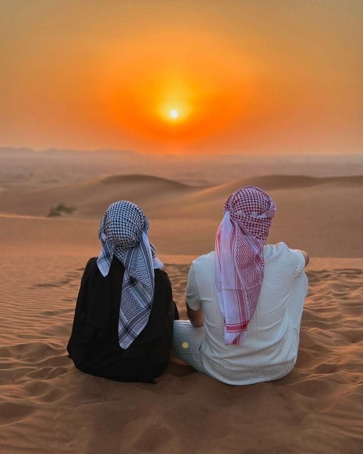 Couple watching the desert sunset