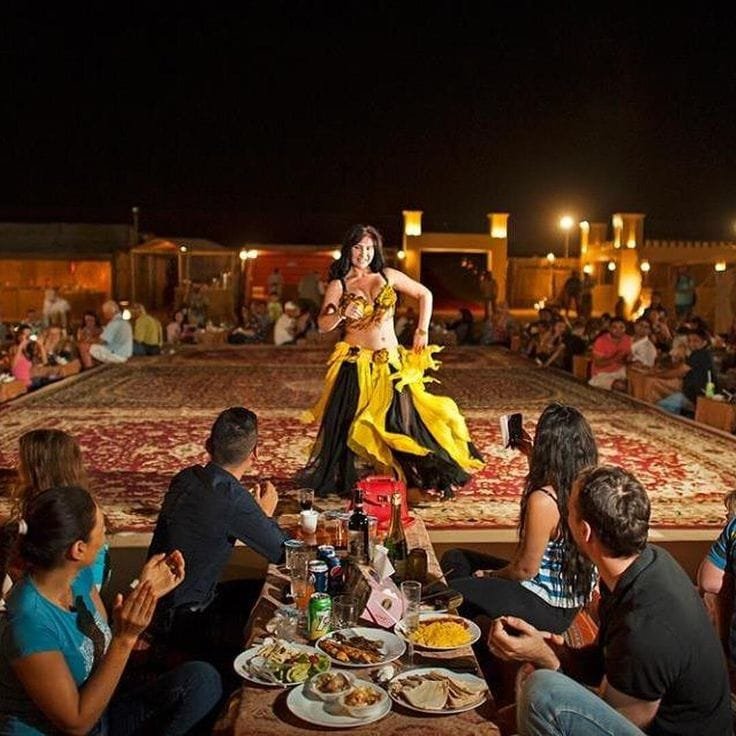 Belly dance performance in front of the VIP seating at a Dubai camp