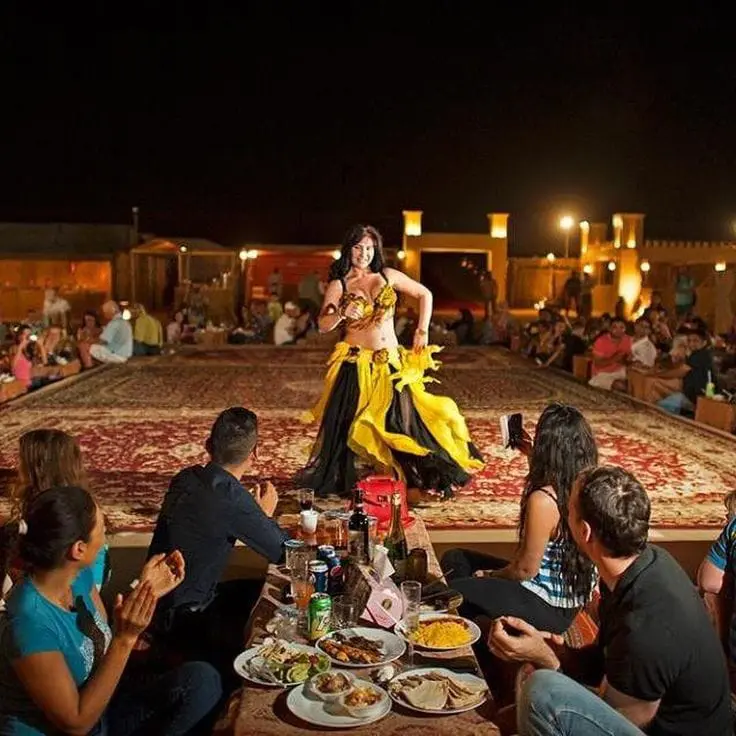 Belly dance performance in front of the VIP seating at a Dubai camp