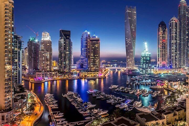 Dubai Marina skyline reflected in the water after dark on a night city tour of Dubai