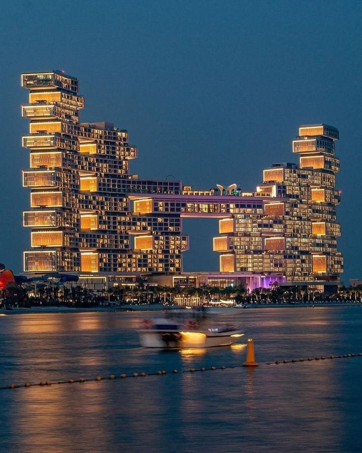 Atlantis The Royal resort lit up at night over the water in Dubai
