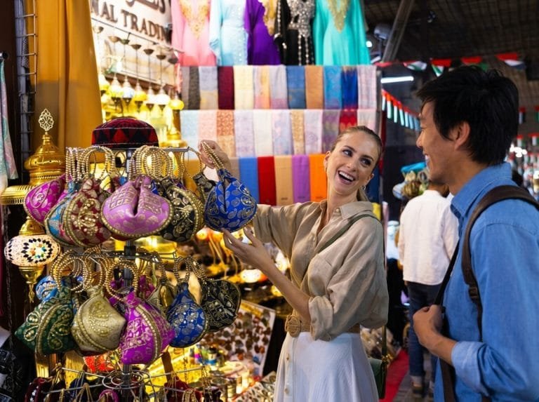 Couple laughing over colourful lamps and trinkets in the old souk
