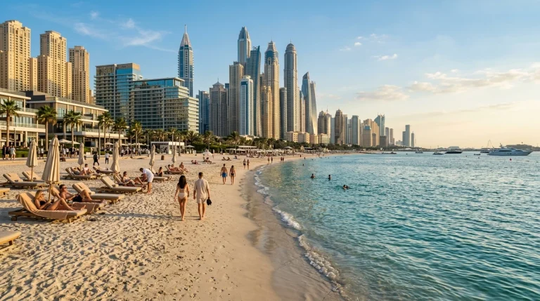 Sun loungers and swimmers at JBR Beach with Dubai Marina towers behind
