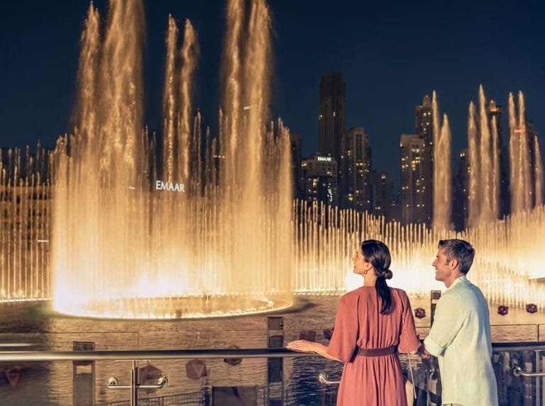 Couple watching the Dubai Fountain show at the foot of Burj Khalifa